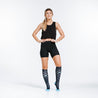 Knee high compression socks in navy blue with light blue dots on model